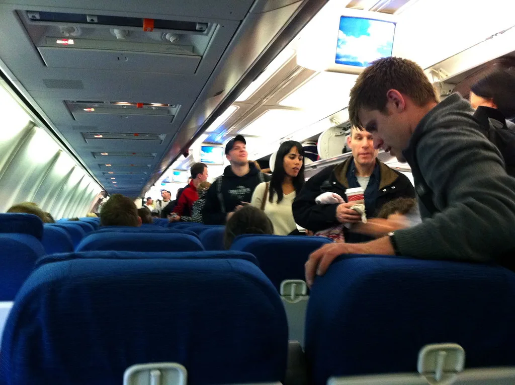 Passengers boarding an airplane from inside of the main cabin